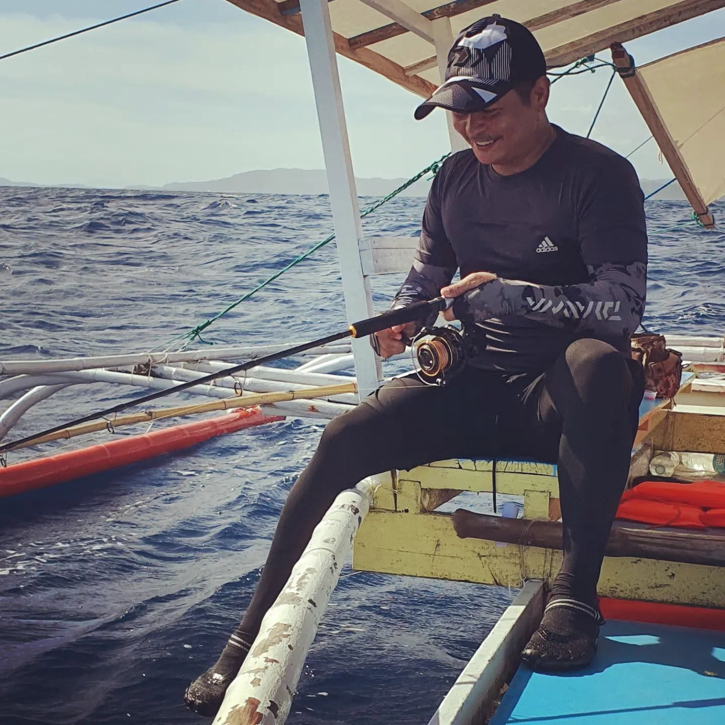 About 12 RM Nisperos fishing from an outrigger boat off Siargao, Philippines